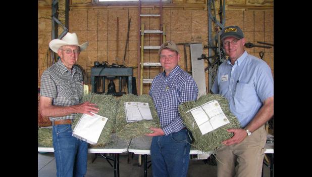 From left, MU Extension specialists Eldon Cole, Andrew McCorkill and Tim Schnakenberg show hay samples at a recent alfalfa tour. Not all good hay looks good. Not all hay that looks good is good hay. Testing tells. Photo by Linda Geist