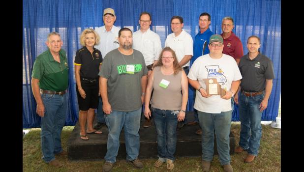 Front row: Jason, Becky and Chase Bowen, Caldwell County 2018 State Fair Farm Family; Back row: MO. State Fair Commissioners: Kevin Roberts, Sherry Jones and Jack Magruder; Blake Naughton, Assoc. Vice Chancellor for MU Extension & Engagement; Rob Kallenbach, Asst. Dean- MU College of Agriculture, Food and Natural Resources; Todd Hays, MO Farm Bureau Board of Director’s Vice President; Mark Wolfe, MO. State Fair Director; Garrett Hawkins, Deputy Director Mo. Dept. of Agriculture.
