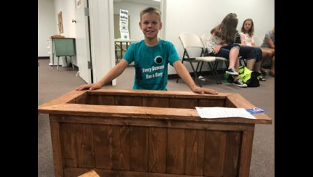 Gage Swindler exhibits his flower box project.