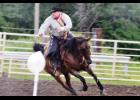Eric Smith shooting at a balloon at the Cowboy Mounted Shooting Competition.