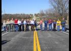 Attending the ribbon cutting ceremony are Commissioners Bud Motsinger (cutting the ribbon) and Gerald McBrayer, Tonya Lohman of MoDOT, Dale and Kay Hartley, Brad Campbell, Jeff Campbell, Sheriff Jerry Galloway and Mitch Allen, Willie and Susie Cook, Marty Gray, Dean Hales and many other who wanted to witness this long awaited event.