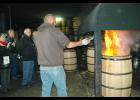 Artisans char whiskey barrels at Barrel 53 in Higbee during the recent White Oak, Whiskey & Wine tour.
